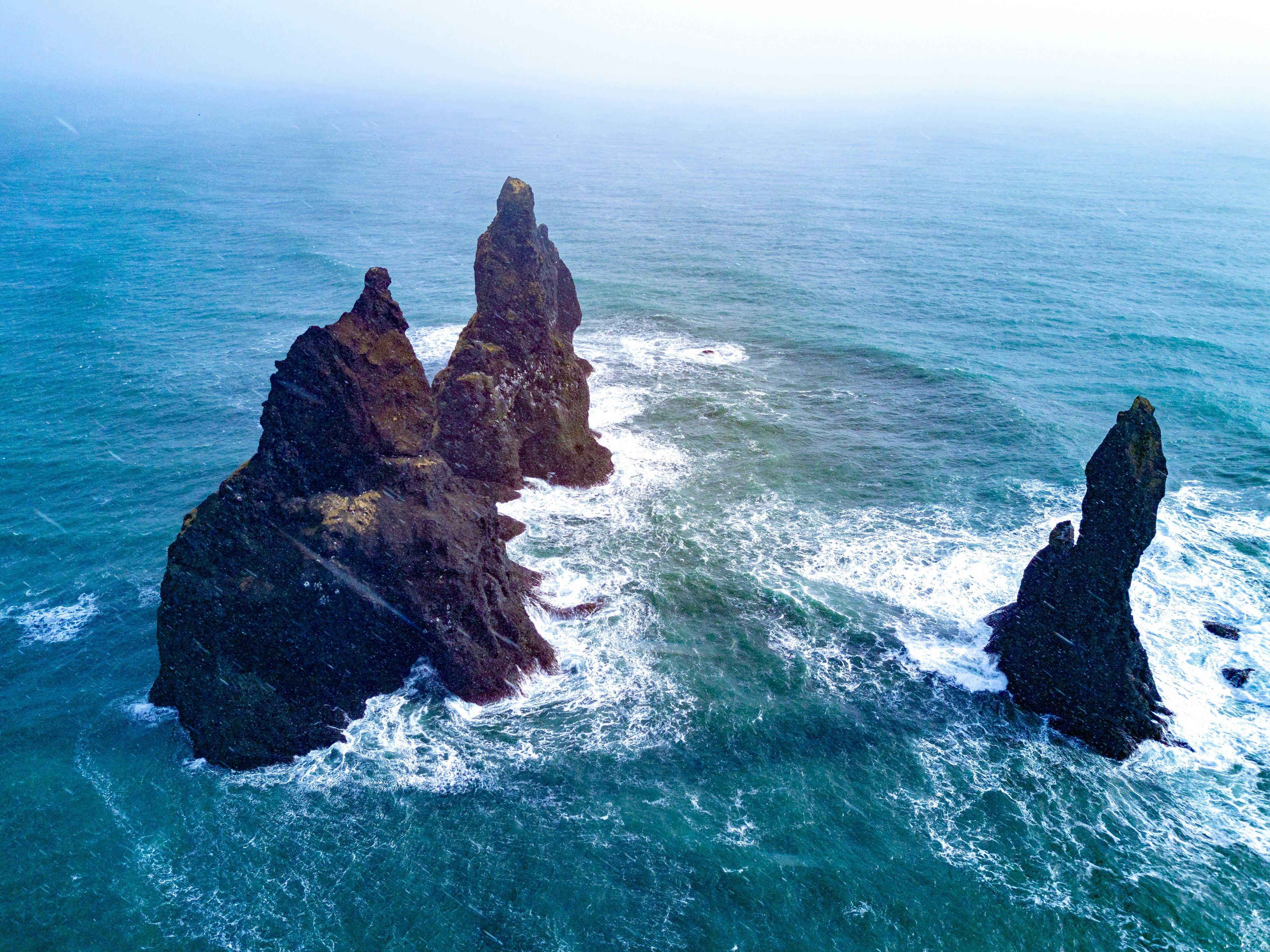 bird's-eye-view photography of rock formation on body of water